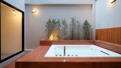 Luxurious modern bathroom with a large jacuzzi and atmospheric lighting