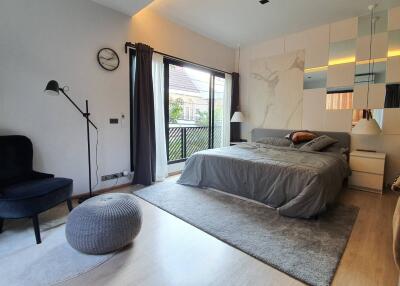 Modern bedroom with elegant interior design, featuring a large bed and balcony access
