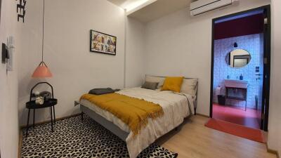 Modern bedroom with a direct view into the stylish en suite bathroom