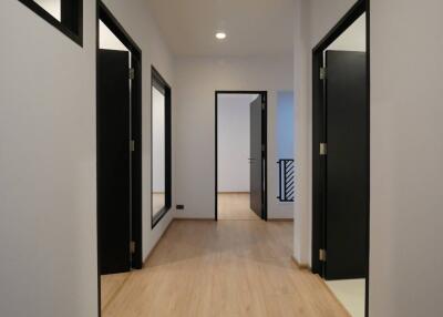Modern hallway interior with wooden floors and white walls