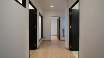 Modern hallway interior with wooden floors and white walls