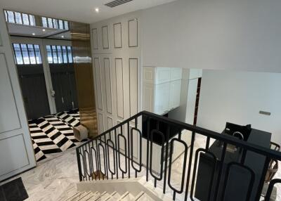Elegant hallway in modern home with marble floors and sophisticated black and white decor