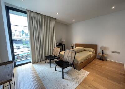 Modern bedroom with large window and city view