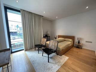 Modern bedroom with large window and city view