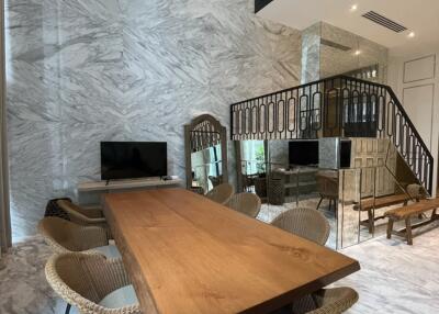 Modern dining room with marble walls and wooden table