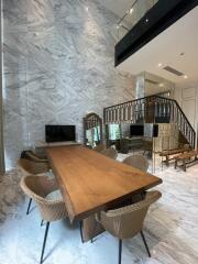 Modern dining room with marble walls and wooden table