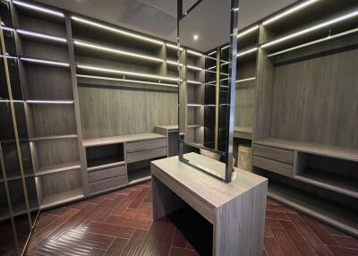 Spacious walk-in closet with custom shelving and integrated lighting