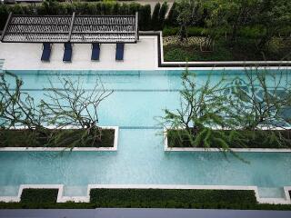 Elegant outdoor swimming pool surrounded by lush greenery