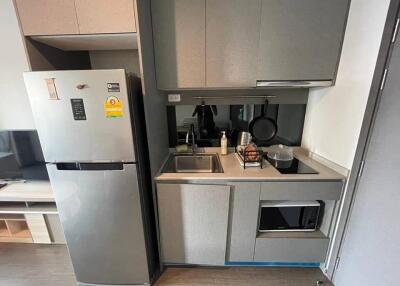 Modern compact kitchen with stainless steel appliances