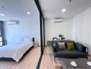 Spacious and modern studio apartment with bed and sofa