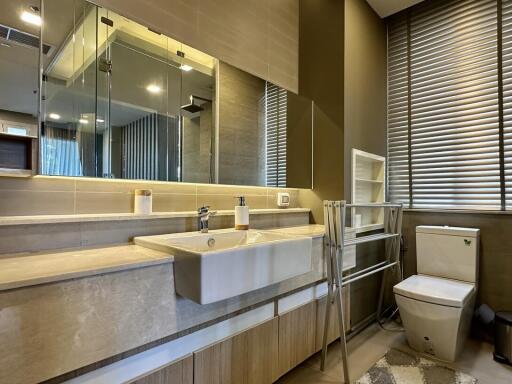 Modern bathroom with spacious vanity, sleek fixtures, and well-lit ambiance