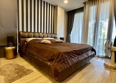 Spacious modern bedroom with large bed and elegant decor