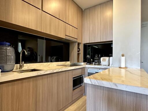 Modern kitchen with wooden cabinets and marble countertops