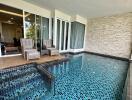 Modern patio with private pool, comfortable seating, and large sliding doors