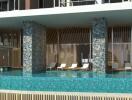 Luxurious poolside area with modern architecture and comfortable lounge chairs