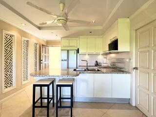 Spacious kitchen with modern appliances and breakfast bar