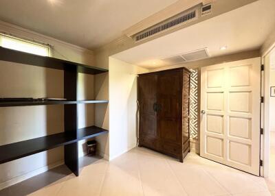 Spacious bedroom with large wardrobe and shelving unit