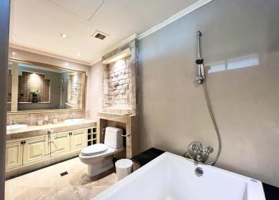 Elegant bathroom with stone accent wall