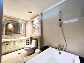 Elegant bathroom with stone accent wall
