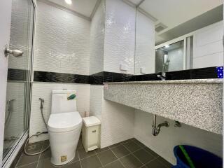 Modern bathroom interior with tiled walls and granite countertop
