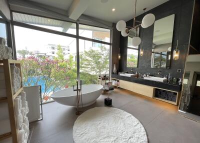 Spacious modern bathroom with freestanding tub and panoramic windows
