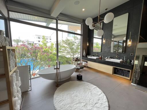 Spacious modern bathroom with freestanding tub and panoramic windows