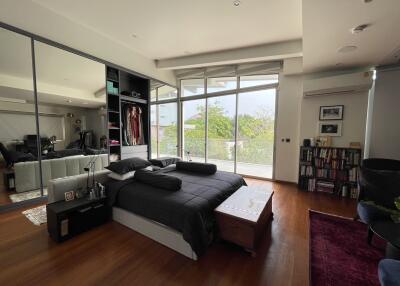 Spacious and modern bedroom with large windows and abundant natural light