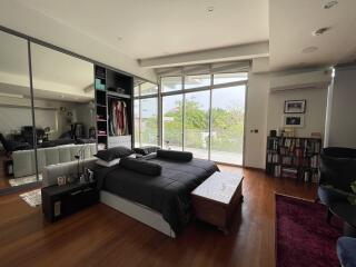 Spacious and modern bedroom with large windows and abundant natural light