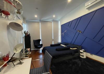 Modern bedroom with blue headboard and stylish furnishings