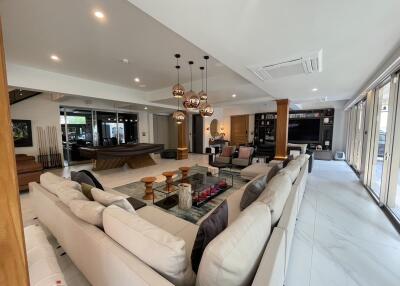 Spacious and modern open-plan living room with integrated kitchen and dining area