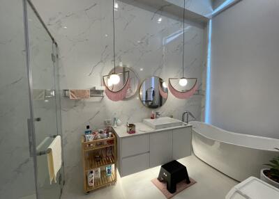 Modern bathroom with elegant design featuring marble walls and stylish fixtures