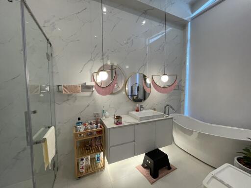 Modern bathroom with elegant design featuring marble walls and stylish fixtures