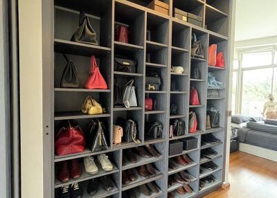 Spacious walk-in closet with organized shoe and bag storage