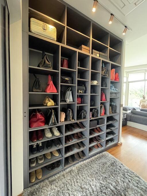 Spacious walk-in closet with organized shoe and bag storage