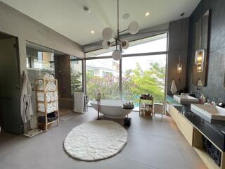 Spacious modern bathroom with freestanding tub and large windows