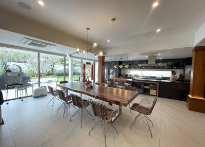 Spacious modern kitchen with integrated dining area and view of the garden
