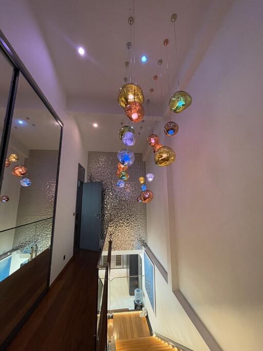 Modern hallway with artistic light fixtures and a sleek design