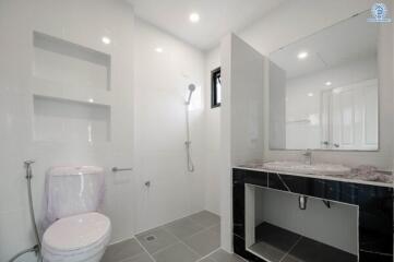 Modern bathroom with spacious shower and sleek vanity