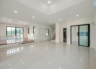 Spacious and bright living room with glossy white floor