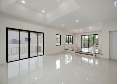 Spacious and bright modern living room with large windows and glossy white floor