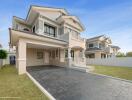 Spacious two-story residential home with large driveway and landscaped lawn