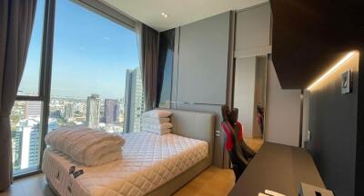 Modern bedroom with large window overlooking the city