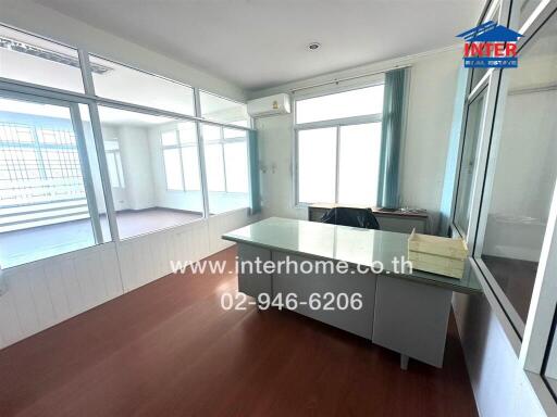 Spacious living room with large windows and ample natural light