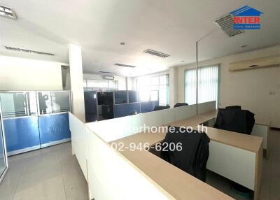 Spacious well-lit office interior with cubicles and modern design