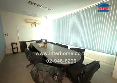 Spacious conference room with large table and chairs
