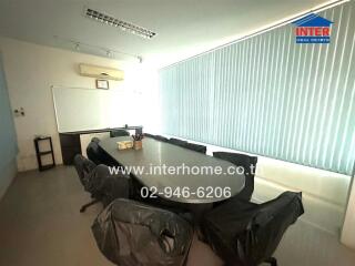 Spacious conference room with large table and chairs