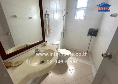 Spacious bathroom with modern fixtures and tiled walls