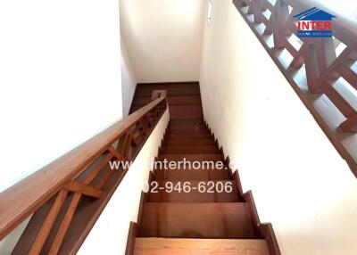 Wooden staircase leading to upper level
