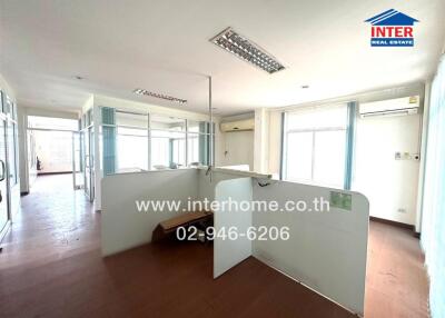 Spacious and well-lit office area with large windows and open floor plan