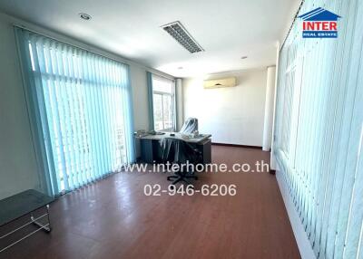 Spacious office room with large windows and ample natural light